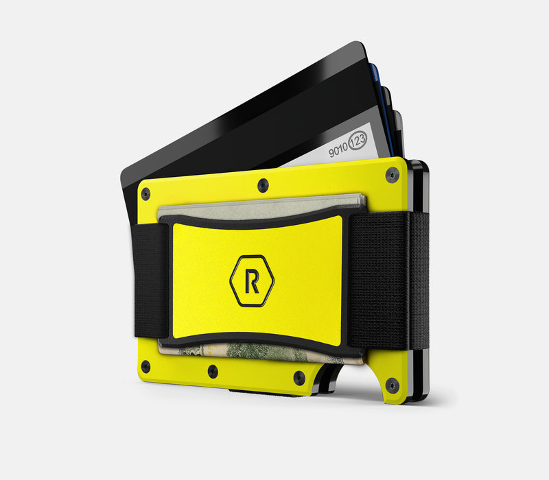 Ridge Wallet in hyper lime, angled view with cash strap, cards fanned out and a folded bill tucked in.