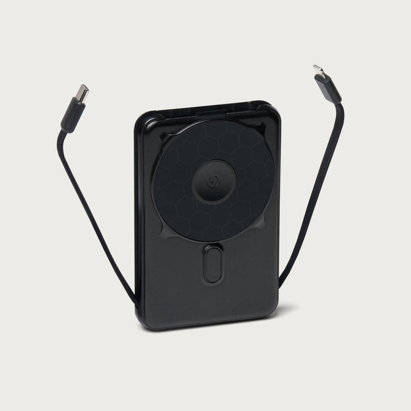 Matte black power bank with wireless charging coil, USB-C and Lightning cables extended on sides.