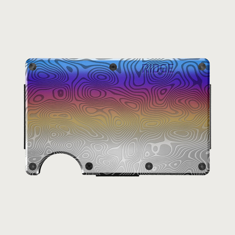 Ridge Wallet - Burnt Damascus, front view showing swirled blue-purple-gold-silver finish with Ridge logo and cash strap.